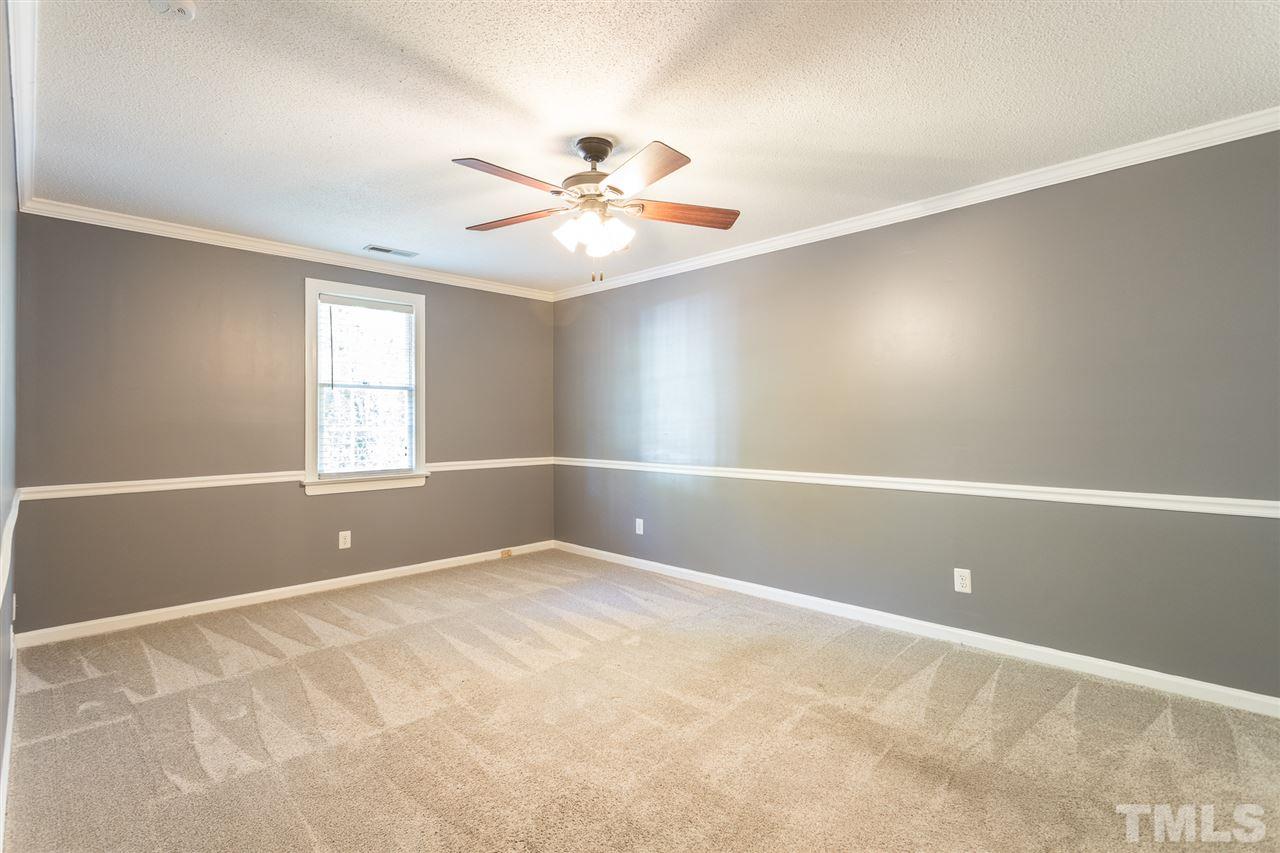 4513 Lancashire Drive Raleigh, NC 27613 - Photo 17 of 25 an empty room with windows and fan
