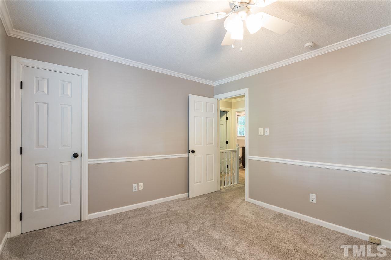 4513 Lancashire Drive Raleigh, NC 27613 - Photo 18 of 25 an empty room with closet and a chandelier fan