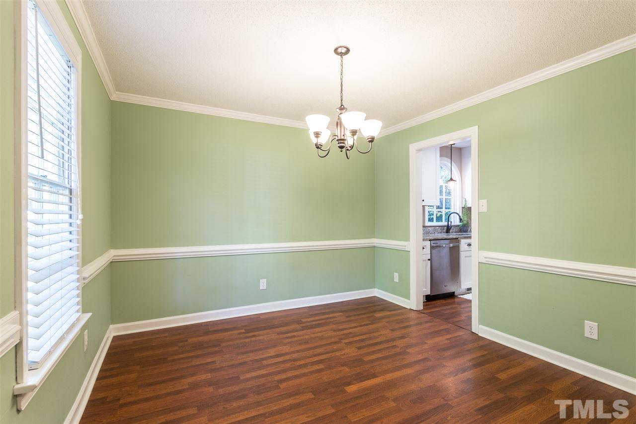 4513 Lancashire Drive Raleigh, NC 27613 - Photo 4 of 25 a view of empty room with wooden floor fan and window