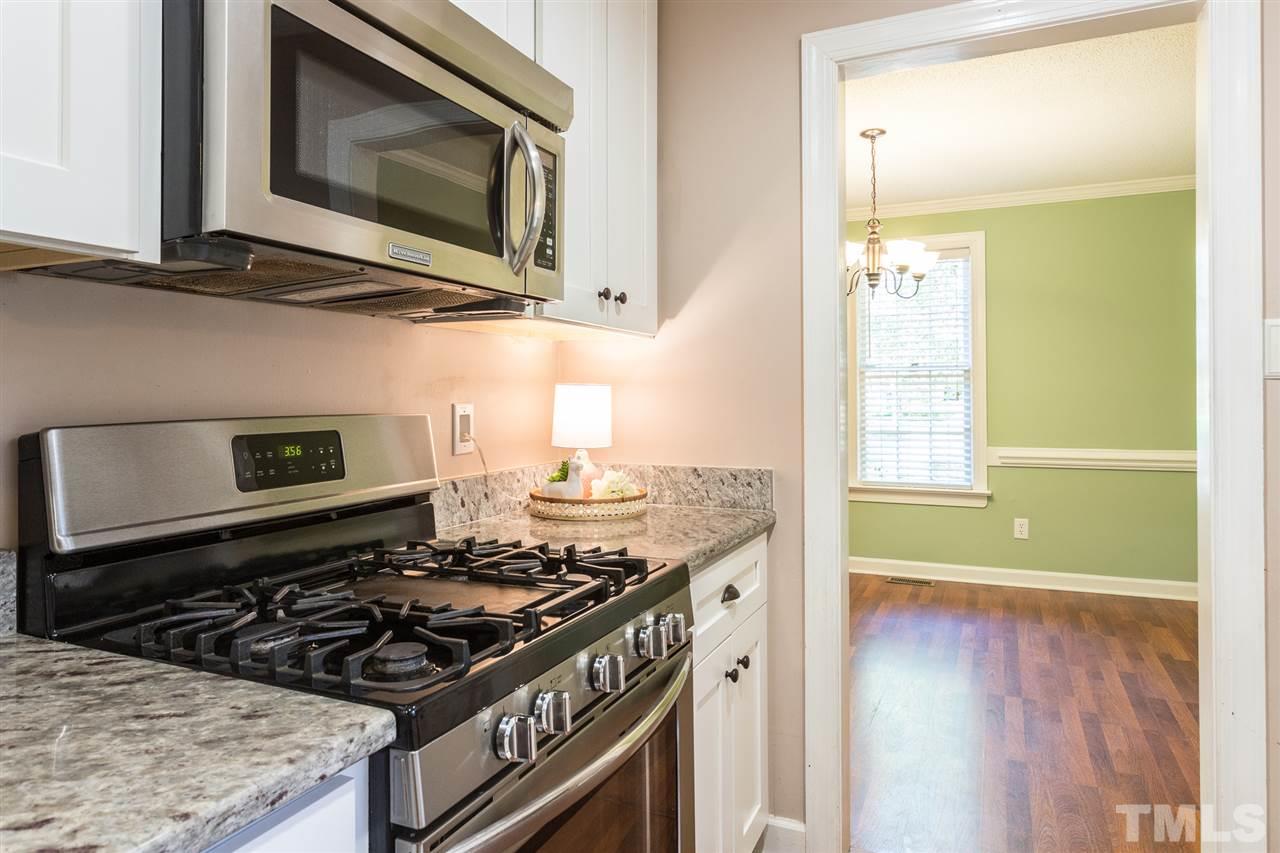 4513 Lancashire Drive Raleigh, NC 27613 - Photo 6 of 25 a kitchen with a stove and a microwave