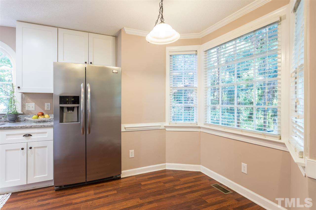 4513 Lancashire Drive Raleigh, NC 27613 - Photo 10 of 25 a kitchen with stainless steel appliances a refrigerator sink and cabinets