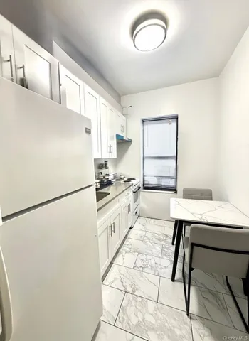a kitchen with stainless steel appliances a refrigerator sink and cabinets