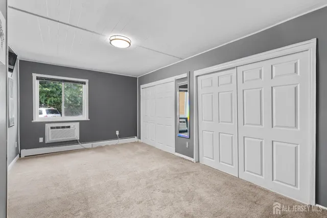 an empty room with windows and closet