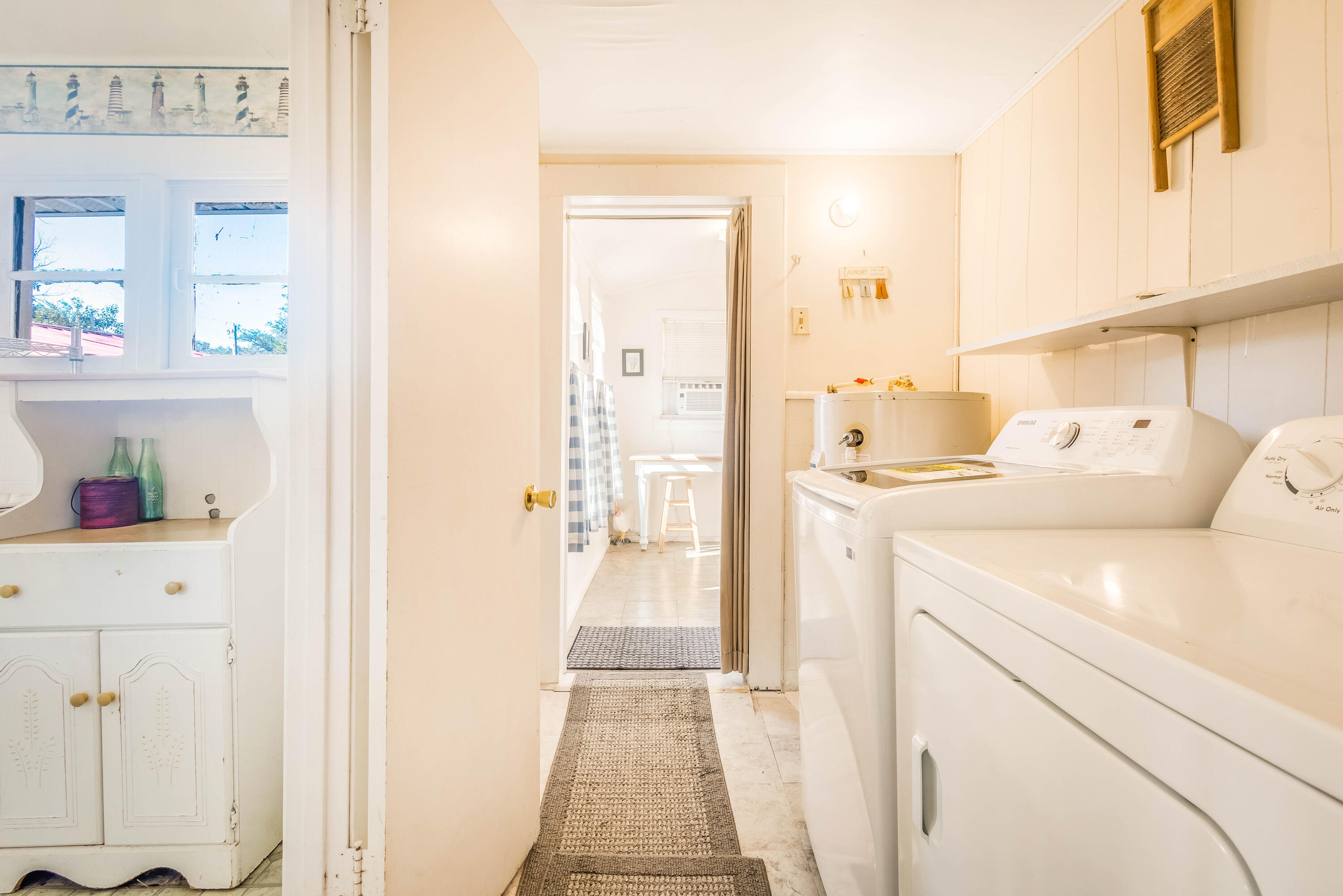 21132 Seminole Street Florala, AL 36455 - Photo 19 of 44 a hallway with white cabinets and washer