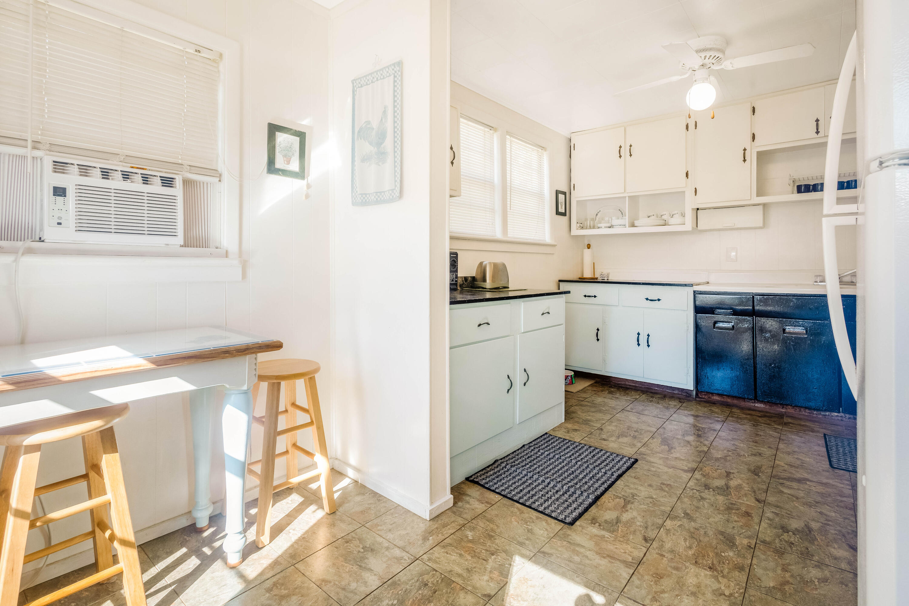 21132 Seminole Street Florala, AL 36455 - Photo 23 of 44 a kitchen with stainless steel appliances granite countertop a sink a stove a refrigerator a microwave and white cabinets