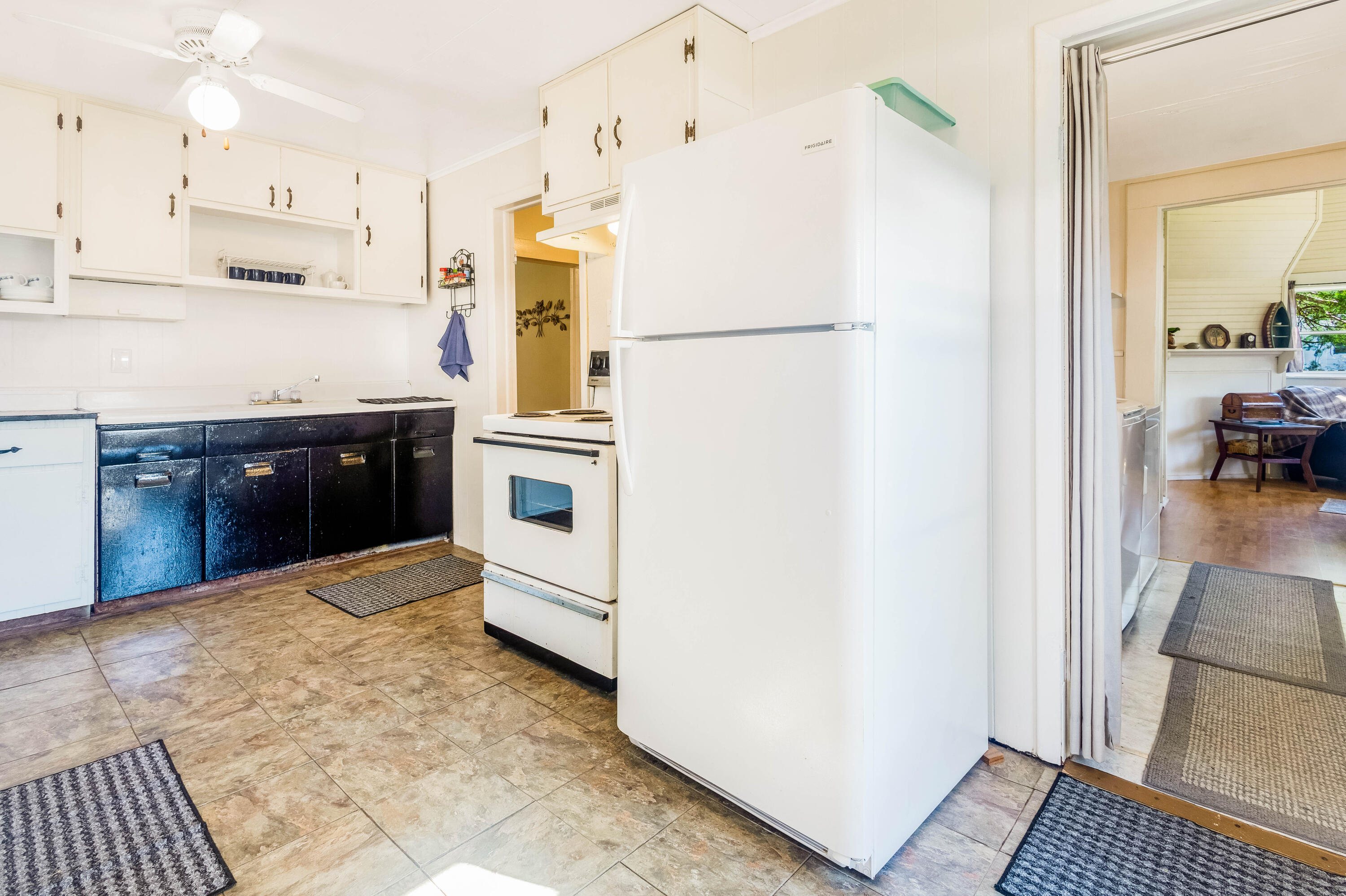 21132 Seminole Street Florala, AL 36455 - Photo 24 of 44 a kitchen with stainless steel appliances granite countertop a refrigerator a stove and a sink with wooden floor