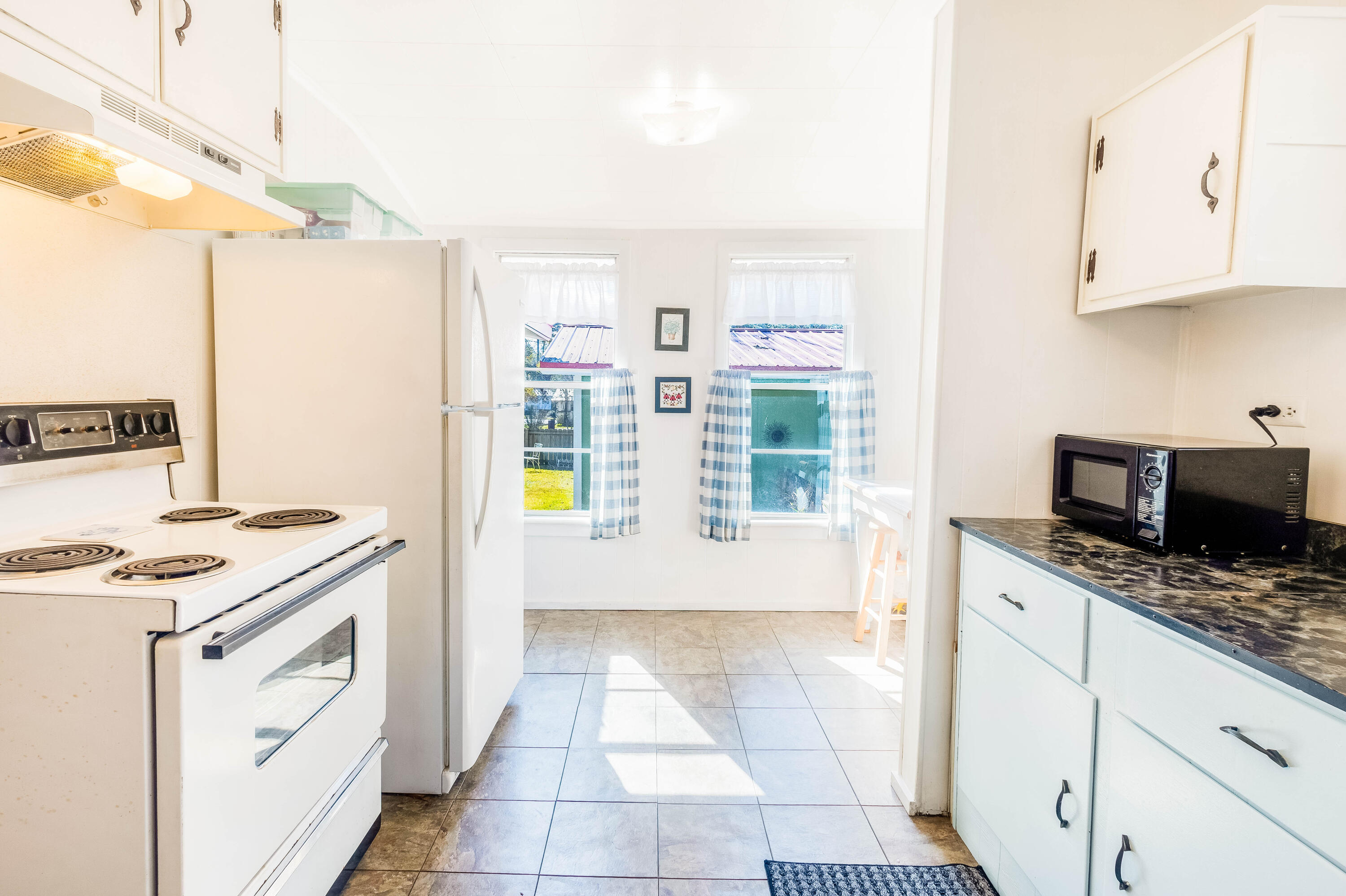 21132 Seminole Street Florala, AL 36455 - Photo 27 of 44 a kitchen with stainless steel appliances granite countertop a stove a sink and a microwave