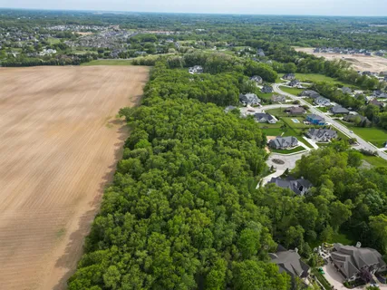 an aerial view of ocean with residential house and outdoor space