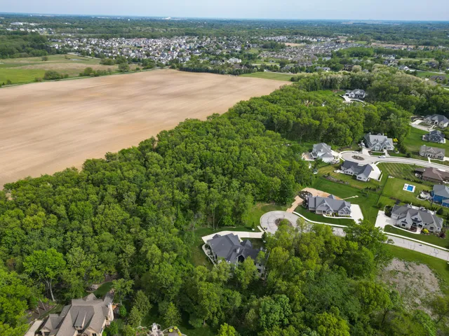 an aerial view of a house with yard
