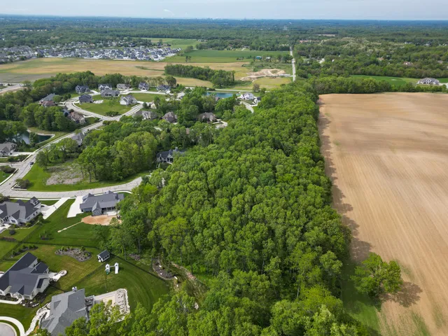an aerial view of a house with garden space and lake view