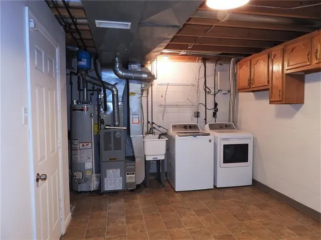 a view of a storage and utility room with washer and dryer