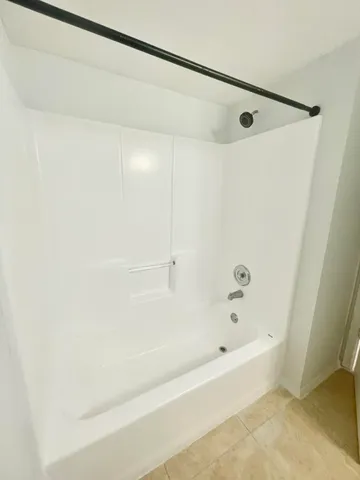 a bathroom with a shower and a bath tub