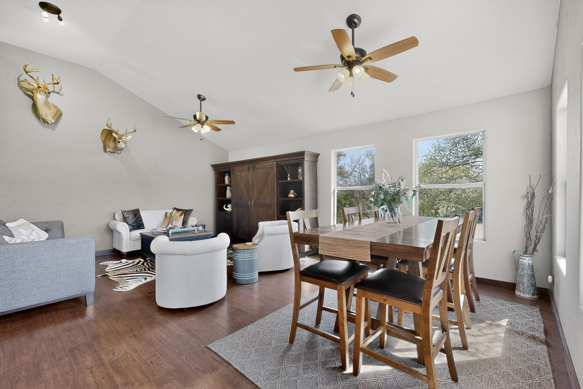 1619 Althaus Ranch Road Johnson City, TX 78636 - Photo 15 of 40 a dining room with wooden floor and a ceiling fan