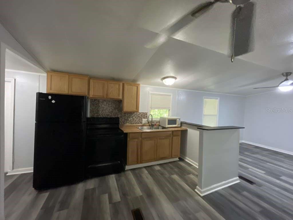 112 Mohawk Lane Altamonte Springs, FL 32714 - Photo 2 of 9 a kitchen with granite countertop a refrigerator and a stove