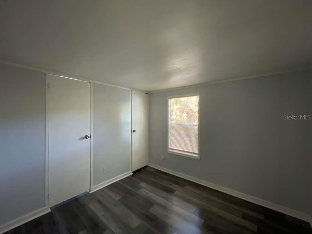 112 Mohawk Lane Altamonte Springs, FL 32714 - Photo 4 of 9 an empty room with wooden floor and window