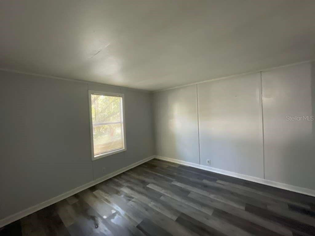 112 Mohawk Lane Altamonte Springs, FL 32714 - Photo 9 of 9 an empty room with wooden floor and windows