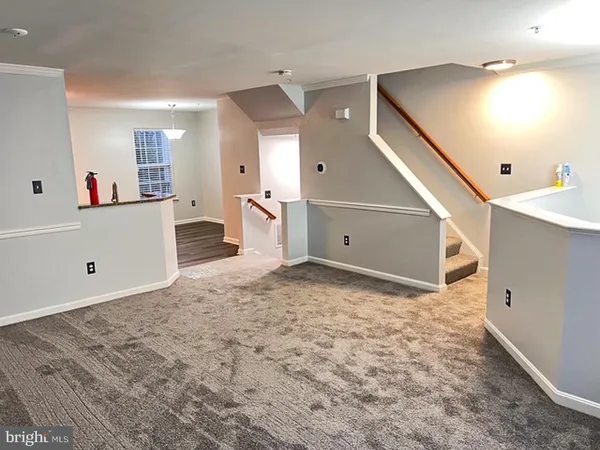 a view of a livingroom with furniture and stairs