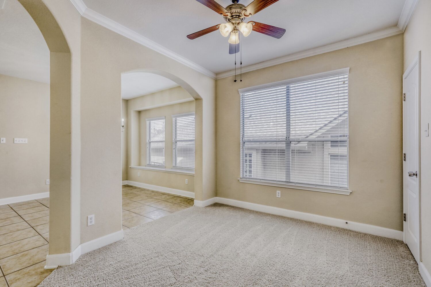 24 Stone Terrace Drive Austin, TX 78734 - Photo 17 of 32 an empty room with chandelier fan and windows