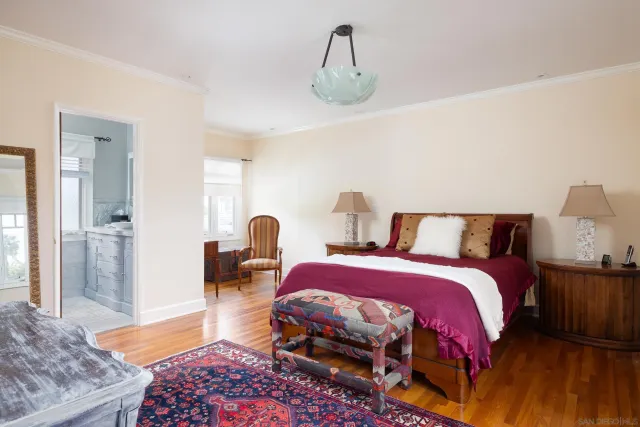 a bedroom with bed and wooden floor