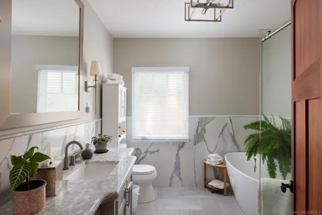 a bath room with a sink and a mirror