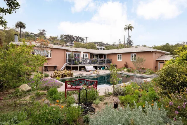a view of a house with pool and chairs