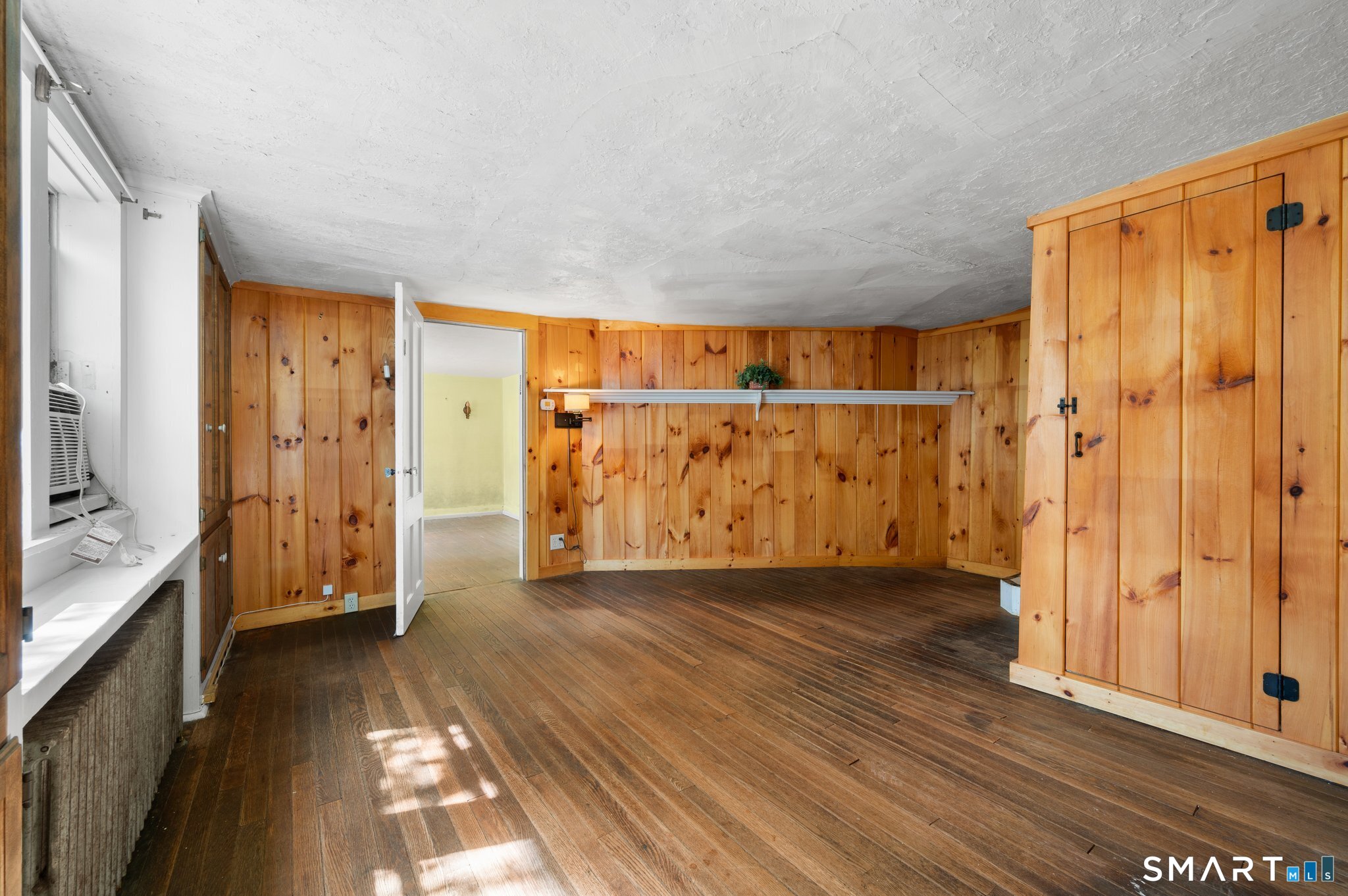 61 Joshuatown Road Lyme, CT 06371 - Photo 9 of 40 First floor LR with wood floors and wood paneled walls