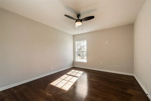 a view of wooden floor and windows in a room