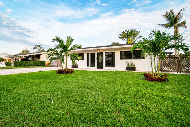 a living room with furniture a flat screen tv and a window