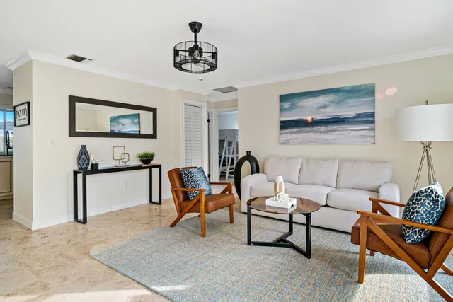 a living room with furniture a flat screen tv and a large window