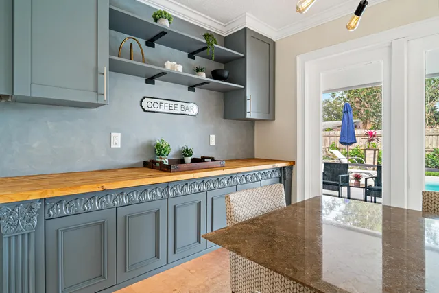 a kitchen with stainless steel appliances granite countertop a refrigerator a stove a sink and a microwave