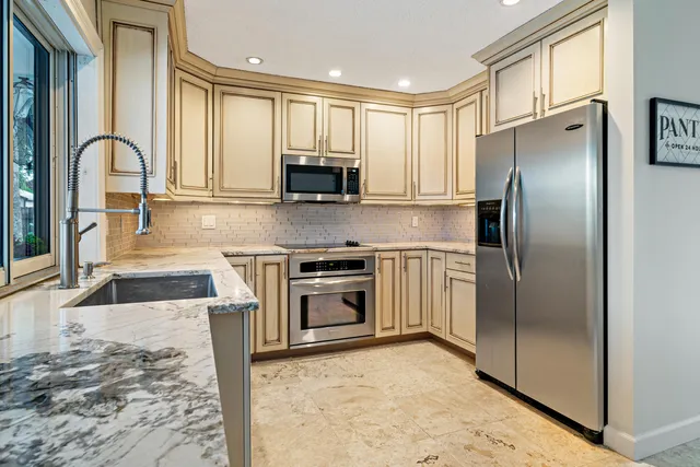 a bedroom with a bed and a lamp with the dresser