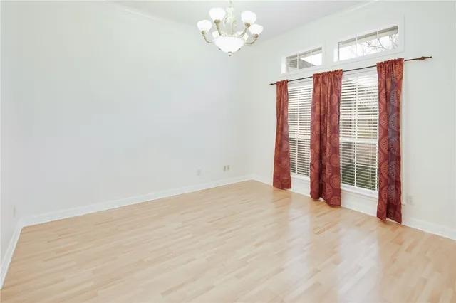 a view of an empty room with a chandelier