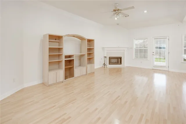 wooden floor in an empty room with a fireplace