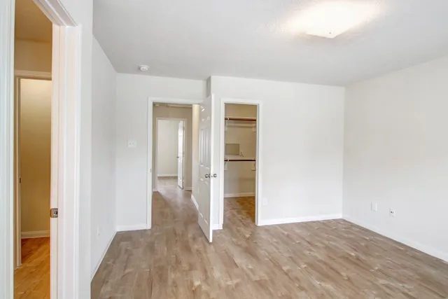 a view of hallway with wooden floor