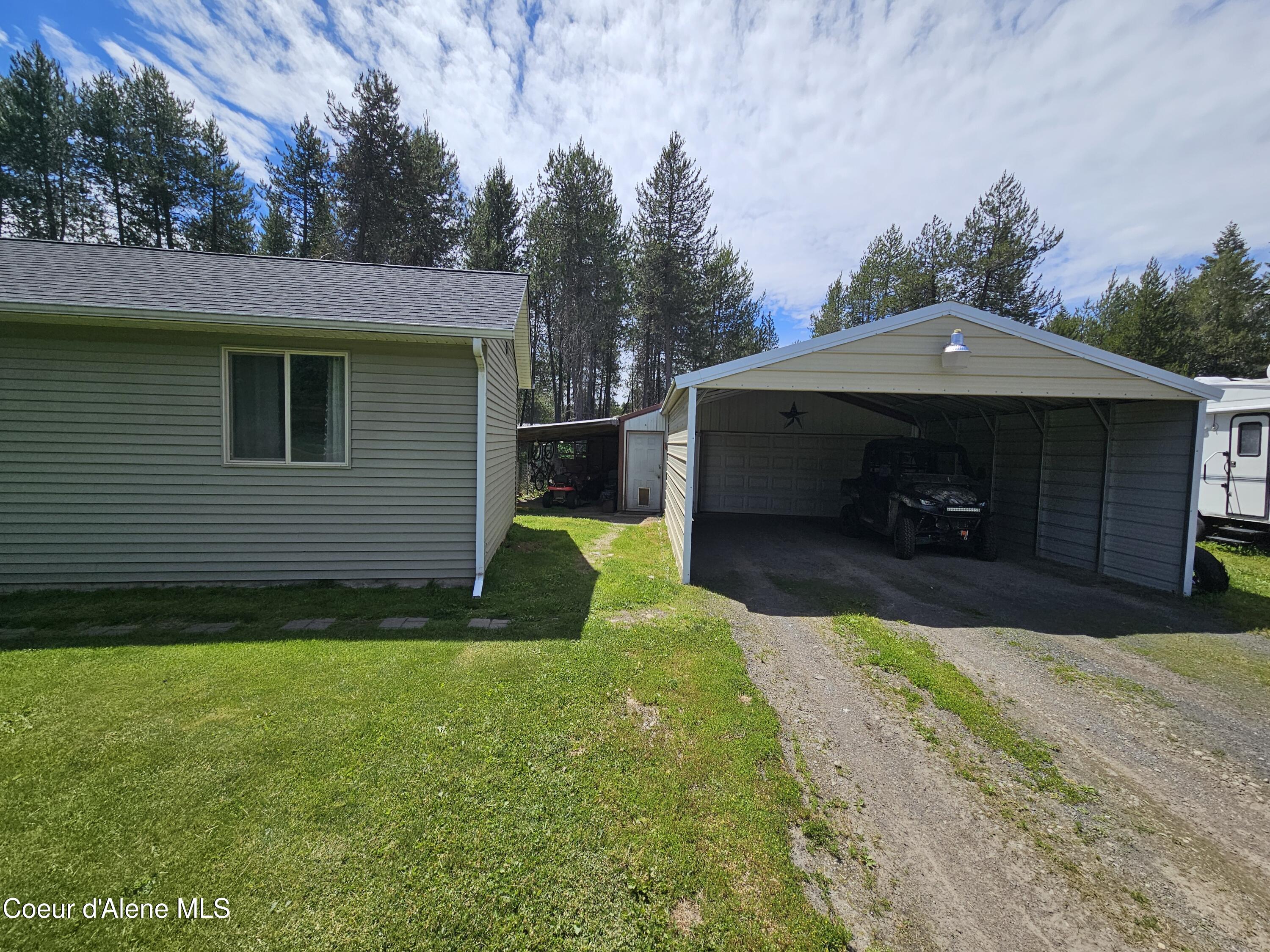 18819 North Ramsey Road Rathdrum, ID 83858 - Photo 22 of 33 Shop w/ Carport in front