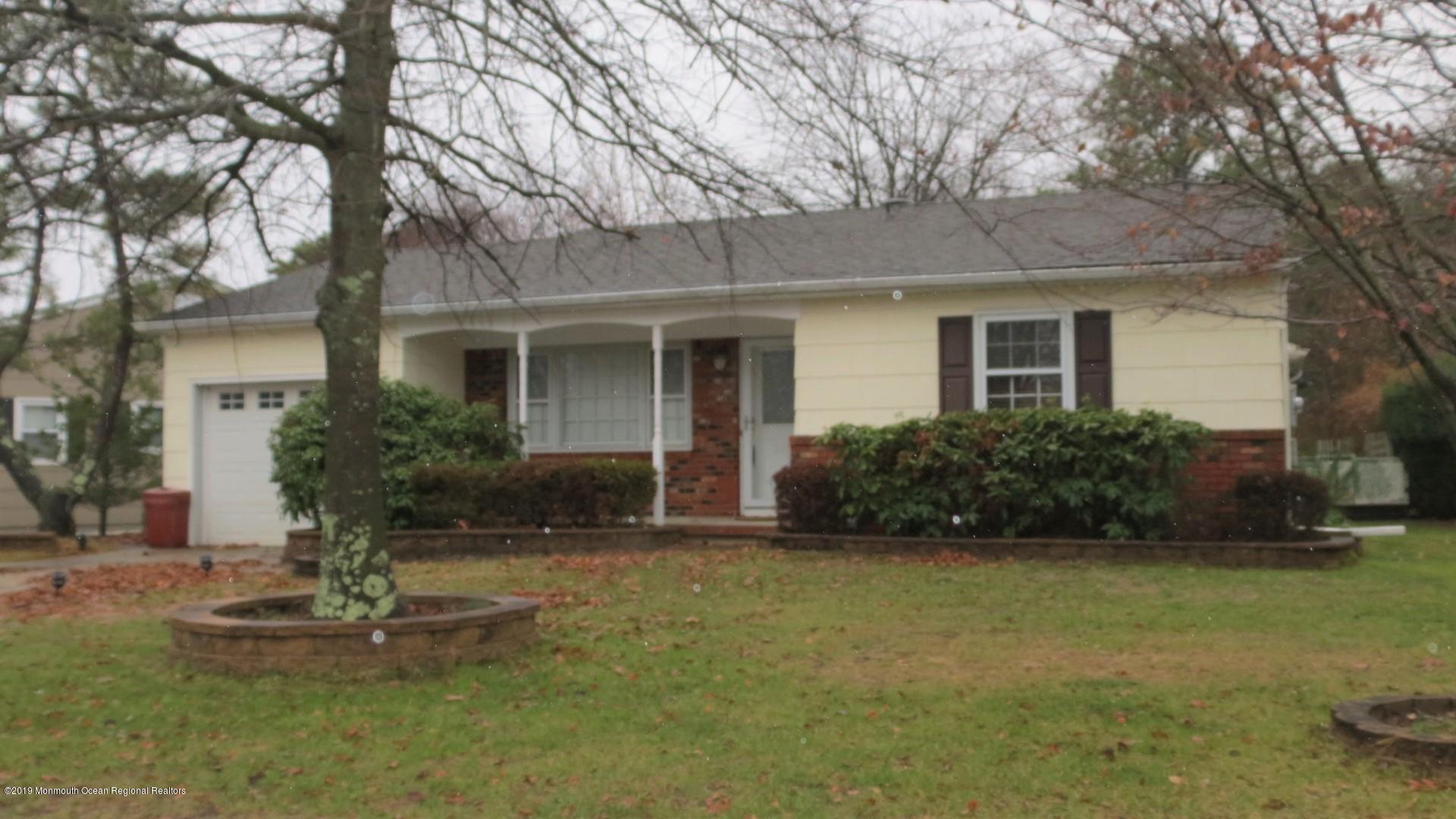 24 Coventry Road Toms River, NJ 08757 - Photo 1 of 21 a front view of a house with a yard and garage
