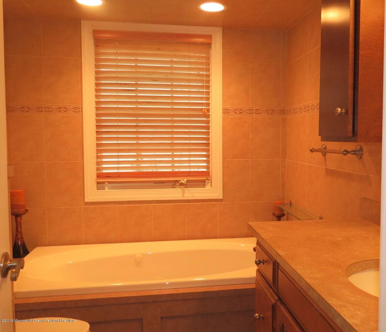 24 Coventry Road Toms River, NJ 08757 - Photo 14 of 21 a bathroom with a bathtub and a sink