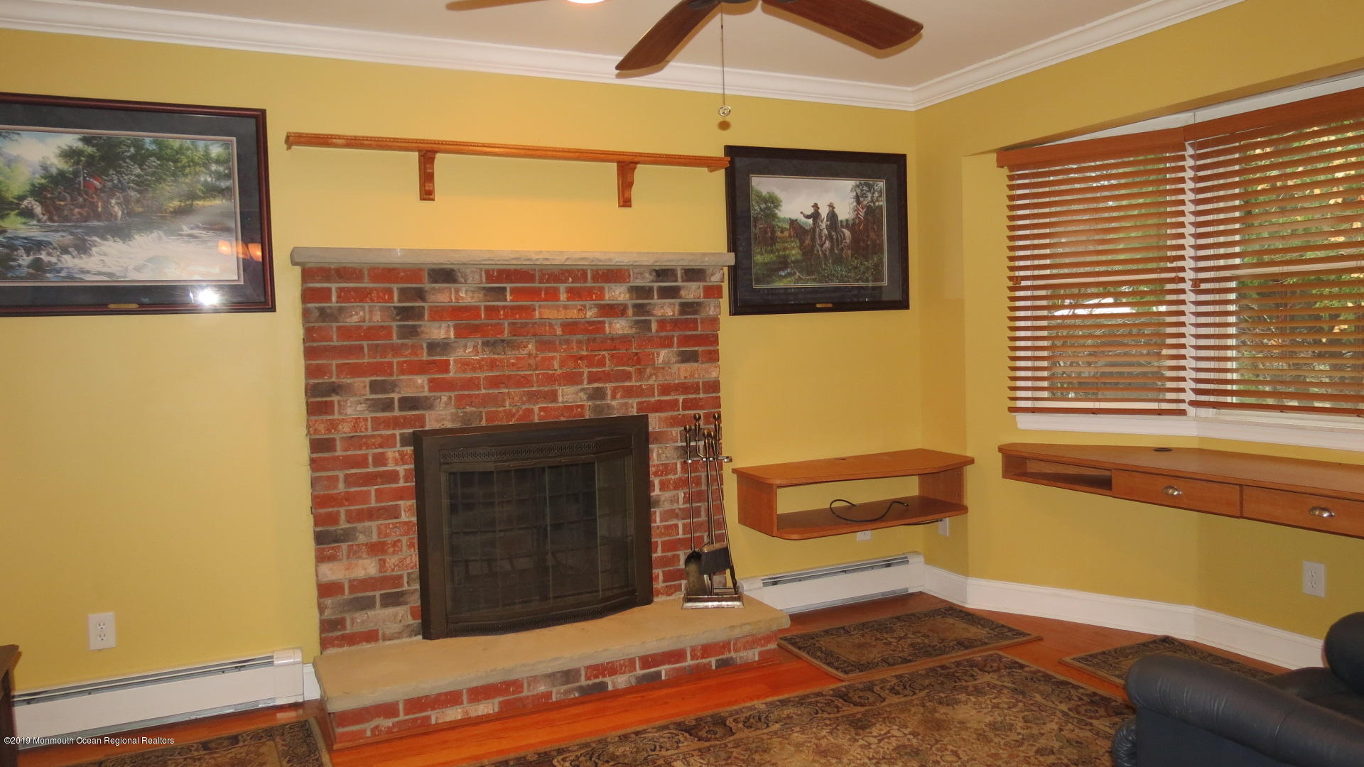 24 Coventry Road Toms River, NJ 08757 - Photo 9 of 21 a living room with a fireplace and a floor to ceiling window