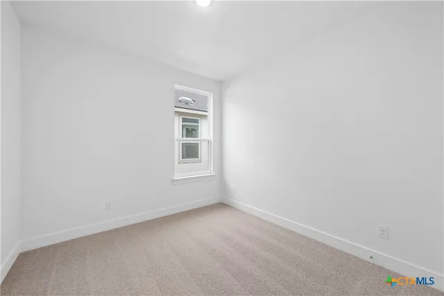 a view of an empty room and window