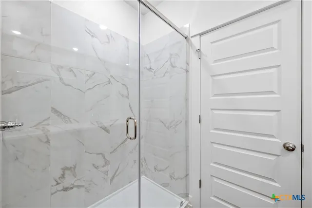 a spacious bathroom with a double vanity sink a toilet and a mirror