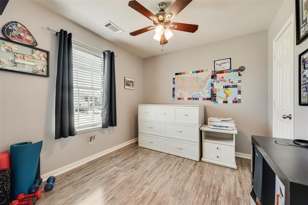 149 Cattlemans Creek Road Newark, TX 76071 - Photo 22 of 39 Third bedroom with laminate floors and ceiling fan at 149 Cattlemans Creek Rd in the Chisholm Springs neighborhood in Newark, TX 76071