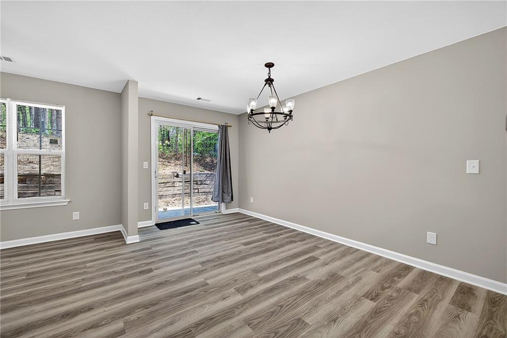 1065 Maple Valley Court Union City, GA 30291 - Photo 12 of 29 a view of a livingroom with wooden floor and a large window
