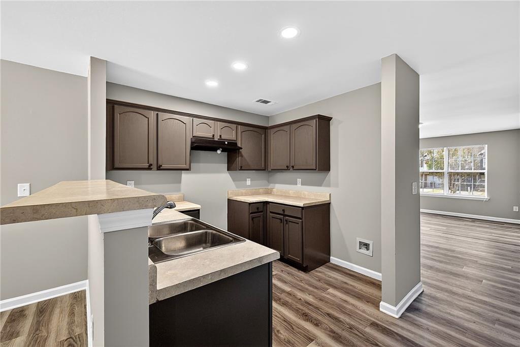 1065 Maple Valley Court Union City, GA 30291 - Photo 13 of 29 a kitchen with a sink a stove and cabinets