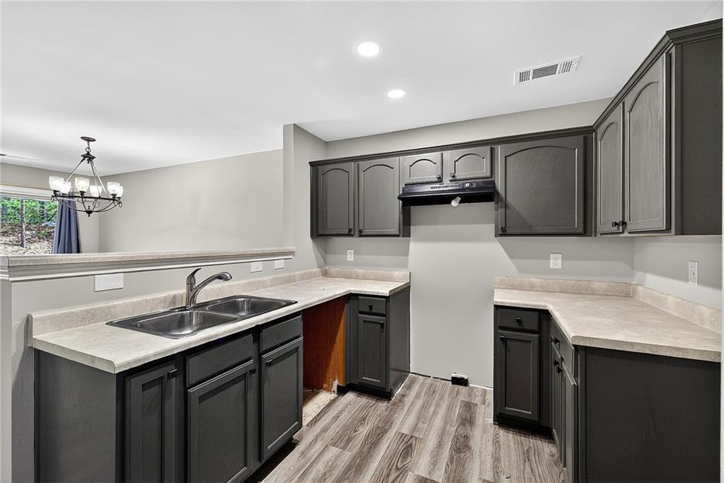 1065 Maple Valley Court Union City, GA 30291 - Photo 14 of 29 a kitchen with granite countertop a sink and cabinets