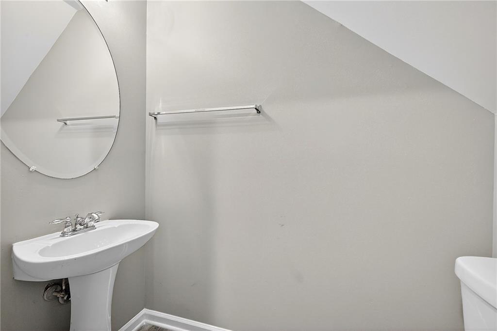 1065 Maple Valley Court Union City, GA 30291 - Photo 15 of 29 a bathroom with a sink a toilet and a mirror