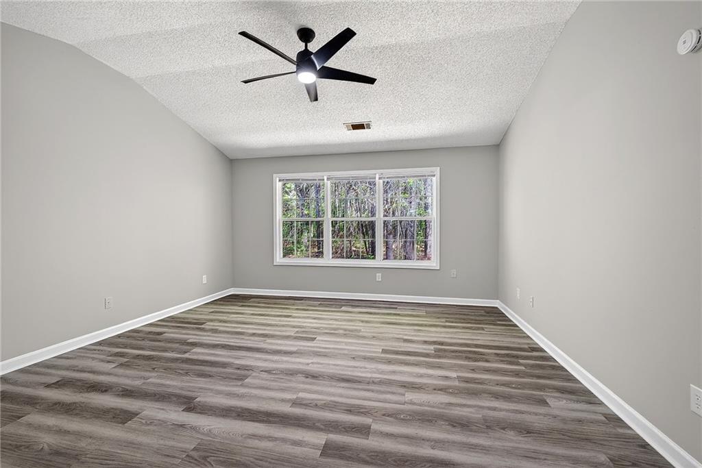 1065 Maple Valley Court Union City, GA 30291 - Photo 16 of 29 an empty room with wooden floor and windows