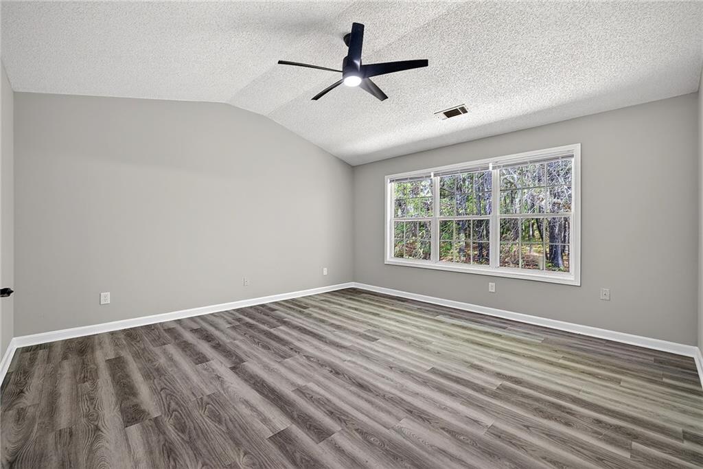1065 Maple Valley Court Union City, GA 30291 - Photo 18 of 29 a view of an empty room with a window and wooden floor
