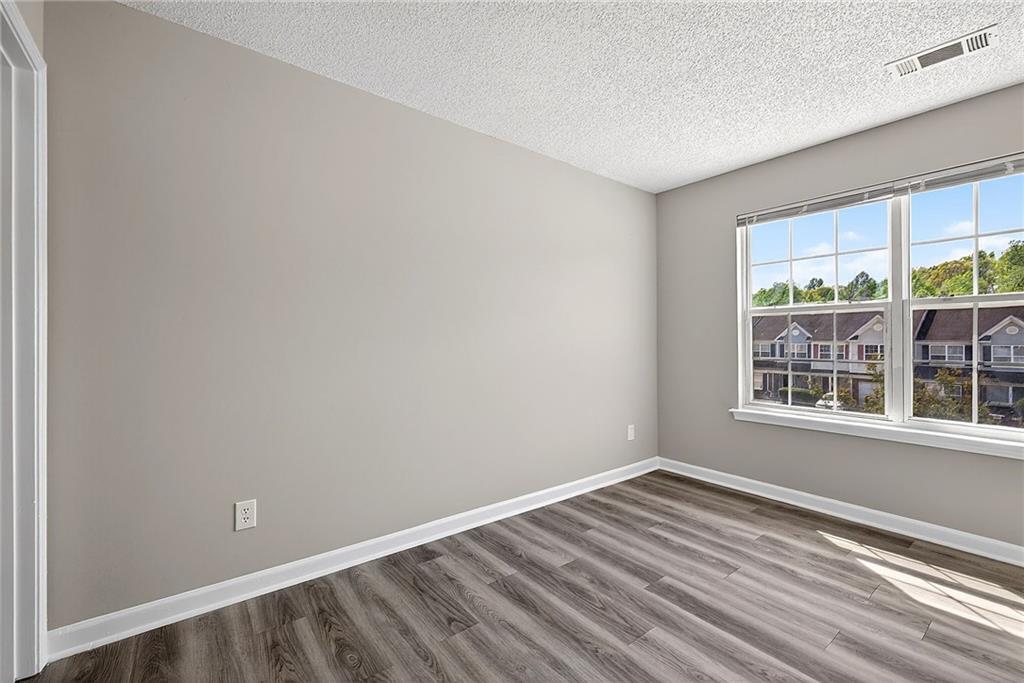 1065 Maple Valley Court Union City, GA 30291 - Photo 21 of 29 a view of empty room with wooden floor and fan