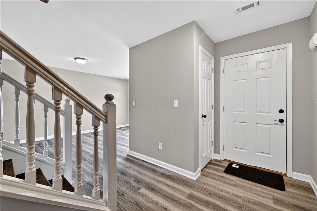 1065 Maple Valley Court Union City, GA 30291 - Photo 4 of 29 a view of a hallway with wooden floor and staircase