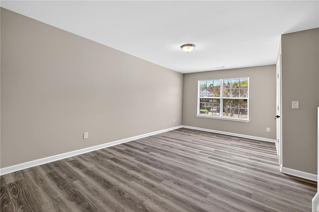 1065 Maple Valley Court Union City, GA 30291 - Photo 7 of 29 wooden floor in an empty room with a window